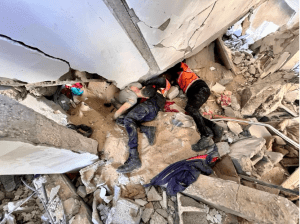 Palestinian photojournalist Haitham Nour Al-Din lies trapped beneath the rubble as crews work to evacuate him after an Israeli airstrike in Khan Yunis, south of the Gaza Strip, on December 23, 2023. (Photo: Courtesy of Haitham Nour Al-Din)