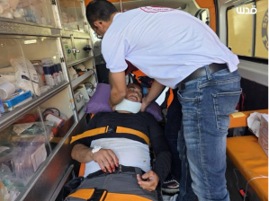 Palestinian freelance photojournalist Issam Rimawi receives medical attention inside an ambulance after he was attacked by Israeli settlers on May 27, 2025, near Ramallah in the West Bank. Rimawi had just finished documenting a group of settlers assaulting Palestinian farmers harvesting wheat. (Photo: Courtesy of Issam Rimawi)