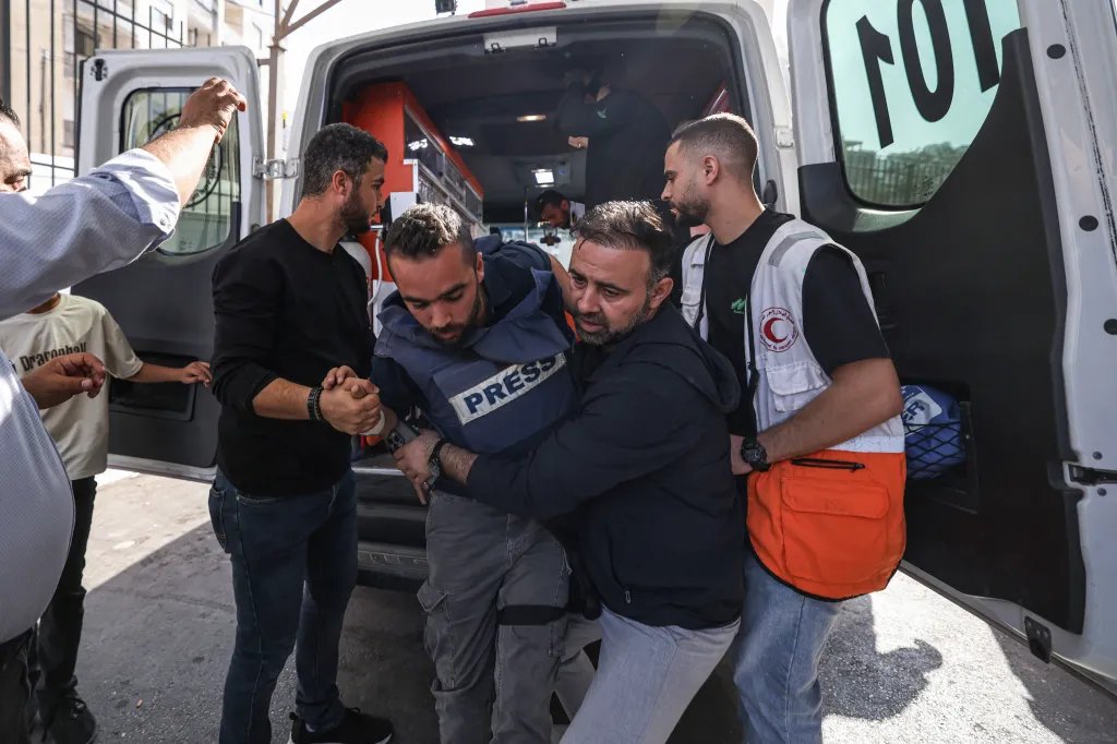 A Palestinian journalist exits an ambulance upon arriving at Rafidia Hospital in Nablus after reportedly being injured by Israeli settlers while covering the olive harvest in the Palestinian village of Baita, in the Israeli-occupied West Bank, on November 8, 2025.