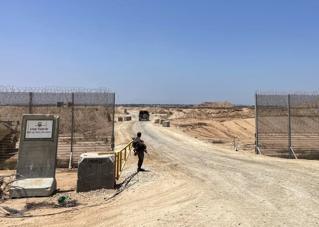 This picture taken on June 8, 2025, shows Israeli military vehicles as they drive through the entrance to the so-called Morag Corridor, during a controlled embed organised by the Israeli military in Khan Yunis in the Gaza Strip.