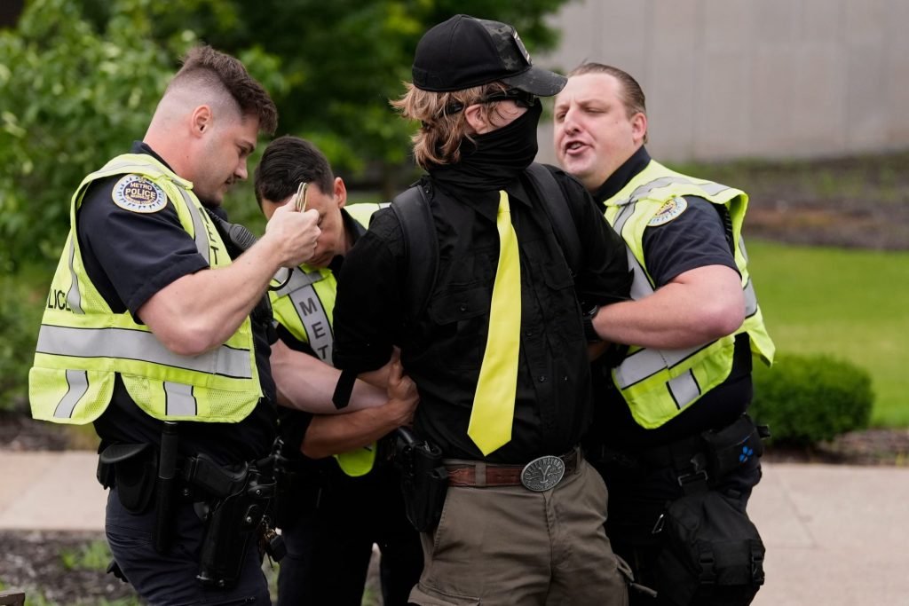 A man is arrested by Metro Nashville Police Department officers as he was carrying a handgun and allegedly harassing demonstrators during a