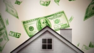 A house is seen with $100 bills falling behind it