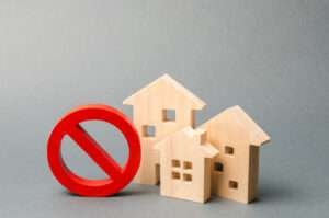 Wooden block homes with a ban sign