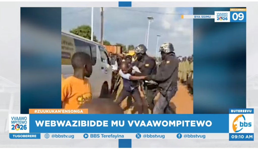 Police prepare to throw journalist Ivan Mbadhi against a vehicle while he was reporting on a Bobi Wine rally.