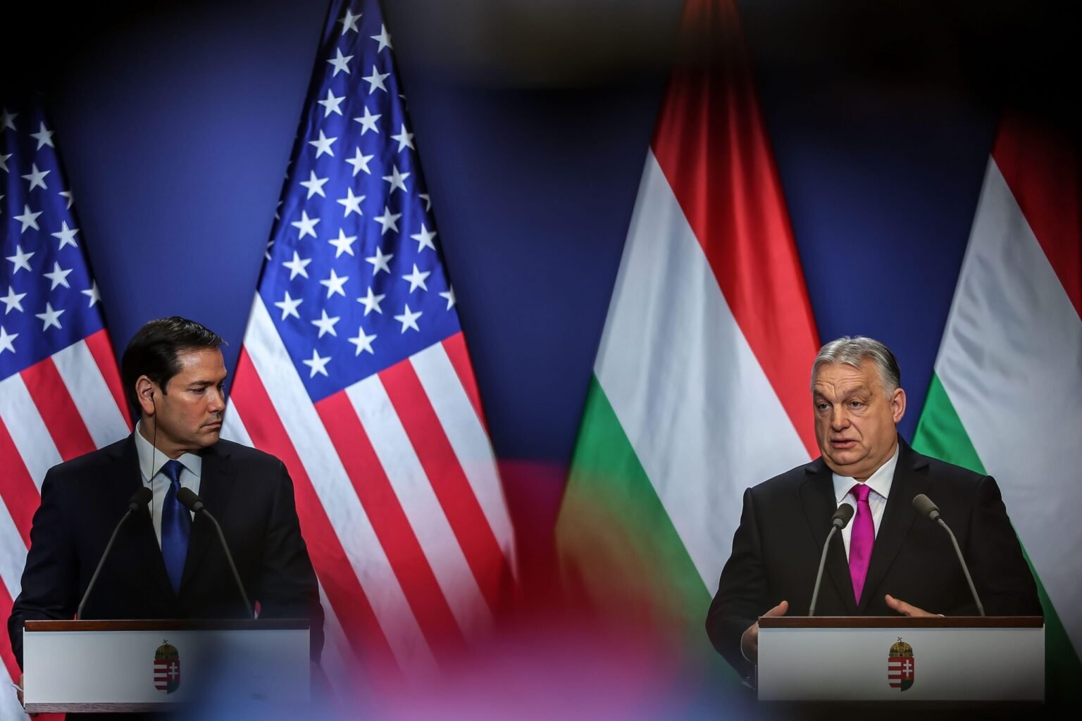 16th Feb, 2026. Hungarian Prime Minister Viktor Orban (R) and U.S. Secretary of State Marco Rubio attend a joint press conference in Budapest, Hungary on Feb. 16, 2026. Photo: David Balogh/Xinhua/Alamy Live News
When I left Hungary on Sunday, the US secretary of state Marco Rubio had just arrived in Budapest for talks with the prime minister Viktor Orbán to give him the USA’s full-throttled support. Hungary has been somewhat of a touchstone for the MAGA movement and Rubio told Orbán that US Hungarian relations were entering “a golden age” and that if Orbán needed anything, the US would consider providing it. There are elections in Hungary just after Easter and it looks likely, if the polls are to be believed, that the more pro-EU opposition leader Péter Magyar will win. There is restrained optimism among many liberals in Budapest although nothing in this part of the world is a done deal. The week I was there, Magyar was going big on the theme that he had been lured into a honey trap and some Kompromat video Russian-style was going to be released. Only a grainy black and white still of a double-bed captured by a ceiling camera ever emerged. Even with a Magyar win, it will be difficult to unravel the total capture of institutions (universities, the media and the cultural centres) by billionaires and those loyal to Orbán’s Fidesz. I heard some 30-something American men in black bomber jackets in Budapest’s Jewish quarter loudly complaining in English that the “young people” in Hungary wanted to tax those billionaires, but they simply didn’t understand how the country relied on them. We are examining the implications on freedom of expression of all these Hungarian developments in the next magazine.
This part of Europe, which was once the Habsburg Empire, feels in flux. People, and particularly young people, are fighting back to claim their rights to be heard. Liberal forces in Slovakia are mobilising, even while the far-right leader Robert Fico is attempting to “normalise” the cultural sector, taking money away from any arts institution considered to be too “activist”. Meanwhile in Vienna, the situation to the east is waved away in the coffee houses as being unimportant, or at least an issue which will resolve itself. A famous saying about the city is: “When the world comes to an end, move to Vienna because everything happens there 20 years later.” There are fears here about an over-dependence on an increasingly unfriendly USA, particularly when it comes to digital platforms and servers – the USA could turn them all off with a flick of a switch if Europe doesn’t toe the line – and a frustration that France and Germany are not working as one to build European solidarity against hostile forces in China and Russia. And then there is a question of the rise of the far-right parties in Europe, including in Austria itself. From the end of World War Two, it was the USA which acted as a liberal guarantor for free expression in western and then eastern Europe. The old order is breaking up, the EU is weakened and ordinary people are having to decide whether those rights are still worth fighting for.
READ MORE 16th Feb, 2026. Hungarian Prime Minister Viktor Orban (R) and U.S. Secretary of State Marco Rubio attend a joint press conference in Budapest, Hungary on Feb. 16, 2026. Photo: David Balogh/Xinhua/Alamy Live News
When I left Hungary on Sunday, the US secretary of state Marco Rubio had just arrived in Budapest for talks with the prime minister Viktor Orbán to give him the USA’s full-throttled support. Hungary has been somewhat of a touchstone for the MAGA movement and Rubio told Orbán that US Hungarian relations were entering “a golden age” and that if Orbán needed anything, the US would consider providing it. There are elections in Hungary just after Easter and it looks likely, if the polls are to be believed, that the more pro-EU opposition leader Péter Magyar will win. There is restrained optimism among many liberals in Budapest although nothing in this part of the world is a done deal. The week I was there, Magyar was going big on the theme that he had been lured into a honey trap and some Kompromat video Russian-style was going to be released. Only a grainy black and white still of a double-bed captured by a ceiling camera ever emerged. Even with a Magyar win, it will be difficult to unravel the total capture of institutions (universities, the media and the cultural centres) by billionaires and those loyal to Orbán’s Fidesz. I heard some 30-something American men in black bomber jackets in Budapest’s Jewish quarter loudly complaining in English that the “young people” in Hungary wanted to tax those billionaires, but they simply didn’t understand how the country relied on them. We are examining the implications on freedom of expression of all these Hungarian developments in the next magazine.
This part of Europe, which was once the Habsburg Empire, feels in flux. People, and particularly young people, are fighting back to claim their rights to be heard. Liberal forces in Slovakia are mobilising, even while the far-right leader Robert Fico is attempting to “normalise” the cultural sector, taking money away from any arts institution considered to be too “activist”. Meanwhile in Vienna, the situation to the east is waved away in the coffee houses as being unimportant, or at least an issue which will resolve itself. A famous saying about the city is: “When the world comes to an end, move to Vienna because everything happens there 20 years later.” There are fears here about an over-dependence on an increasingly unfriendly USA, particularly when it comes to digital platforms and servers – the USA could turn them all off with a flick of a switch if Europe doesn’t toe the line – and a frustration that France and Germany are not working as one to build European solidarity against hostile forces in China and Russia. And then there is a question of the rise of the far-right parties in Europe, including in Austria itself. From the end of World War Two, it was the USA which acted as a liberal guarantor for free expression in western and then eastern Europe. The old order is breaking up, the EU is weakened and ordinary people are having to decide whether those rights are still worth fighting for.
READ MORE