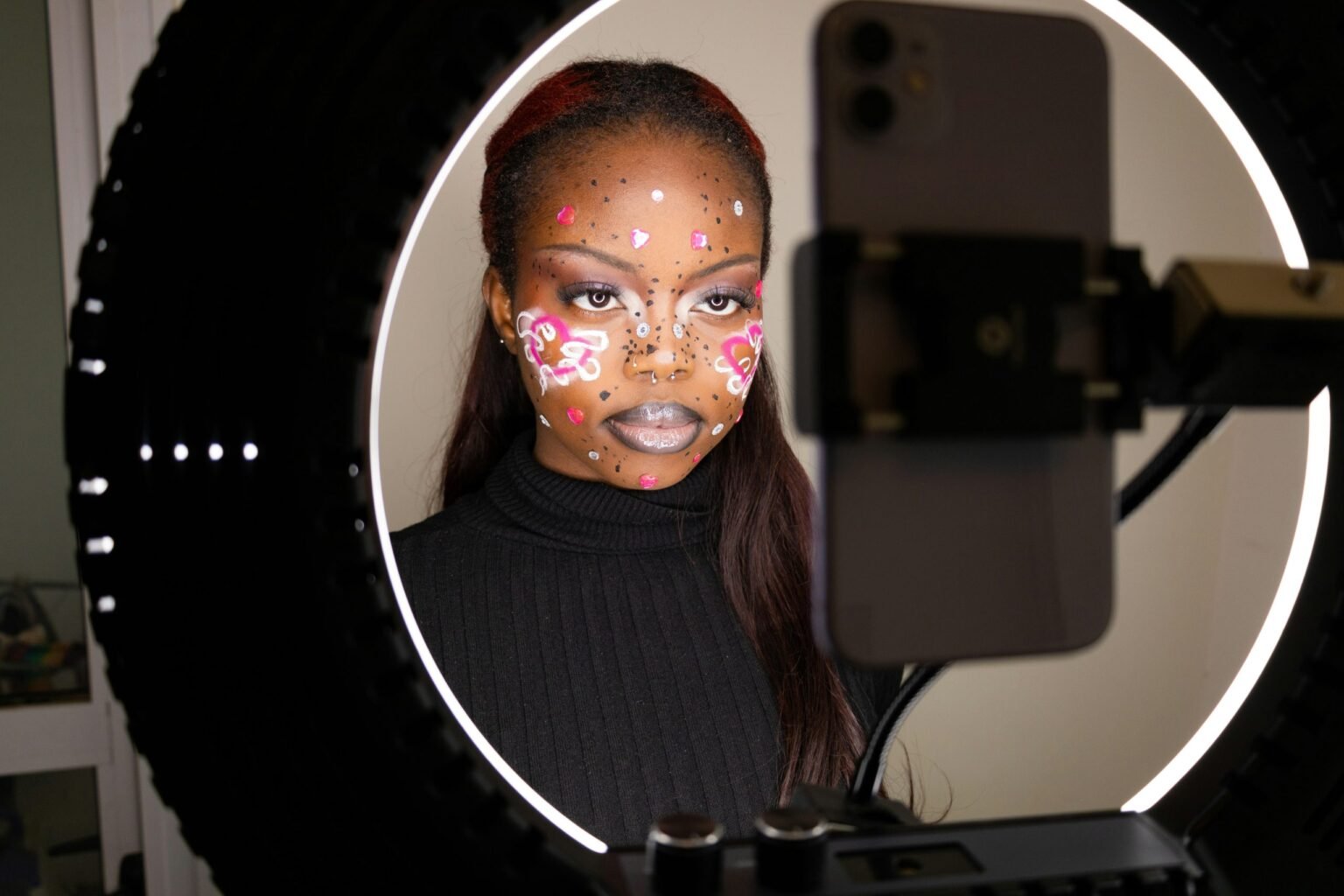 Creators have only three seconds to hook users before they scroll away. Photo: Ben Iwara/Unsplash

				
				
				
				
				Short-form video is the medium of our time. The average teenager will spend hours a day on TikTok and Instagram reels, which are the main sources of news and entertainment for the 18-24 demographic.
Adam Mosseri, head of Instagram, administers the most important algorithm in the English-speaking world. He is undoubtedly as consequential as David Zaslav or Rupert Murdoch – the CEO of Warner Bros and the owner of News Corp – but his name rarely makes headlines.
On Mosseri’s Instagram, videos proven to hold users’ attention will be shown to more people. “Watch-time” is the basic currency of his algorithm. This has forced creators, many of whom earn a living on the platform, to abide by a golden formula: hook, secondary hook, payoff.
The algorithm has spawned an entire coaching industry in which aspiring influencers pay veteran creators for crash courses in perfecting the formula. Each course teaches more or less the same thing: promise the viewer an answer to a question, keep promising, then answer at the end. Better yet, don’t answer it – promise to answer it in the next video.
Where watch-time is the quantitative component of these algorithms, “trends” are the qualitative. If a particular word, image or sound appears to be trending among a certain data demographic, unrelated content will be algorithmically choked out of that demographic’s feed. This forces creators to cluster their content around proven trends.
A trend is never a story. It is always a concept or feeling that can be immediately communicated within three seconds, because it is generally understood that creators have only three seconds to hook users before they scroll away. As influential creator coach Dominik Rieger will often remark: “The viewer must immediately know ‘This is for me’.”
When Sean “Diddy” Combs trends, as he often does, it is never regarding a piece of evidence or a development in one of his trials. What is, on paper, a story about sexual coercion and exploitation of power is translated by the algorithm into a static portrait: a shame-faced Puff Daddy slick with baby oil. Searching “Diddy” will take you to a trove of baby oil related brainrot, and barely a single piece of factual reporting. Diddy’s actions did not create a story to be followed but a crude vignette to be gawked at.
When US president Donald Trump’s shocking birthday letter to Jeffrey Epstein was published by The Wall Street Journal, it did not become a major trend on TikTok or Instagram because the only way to parse the story was by reading the letter itself, which takes more than three seconds. As far as the algorithm is concerned, if an event’s essence cannot be compressed into a three-second span, it may as well have never happened. The proliferation of short-form video has created a media environment structurally hostile to sequential reasoning.
Young people’s attention is guided by an ever-narrowing algorithmic spotlight. Stories that are too big to be rendered by the spotlight are able to bask in pitch darkness and the people we allow to control the algorithms are not interested in changing that. In fact, Mosseri has been open about his efforts to speed up trends: “I want us to be better at trends. It takes still too long for things to pop on Instagram.”
The political implications of this media environment are clear. If short-form video platforms continue to transmute real-world events into less-than-superficial spectacles, the rich and powerful need not manually censor anything. If all chains of cause and effect have found their terminus in the platform algorithms, and if public consciousness is held inert by the same three-second hooks, what will be worth censoring?

			
			
					
				
				
				
				READ MORE