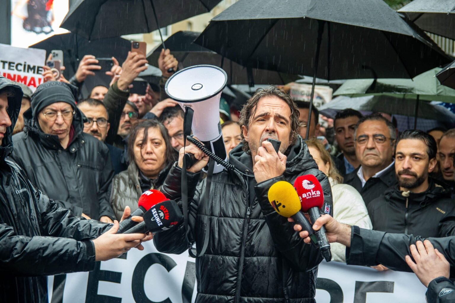 Journalists gather to issue a public statement addressing increasing pressure on the press in Turkey, highlighting arrests, detentions, and legal actions targeting reporters. Photo: ZUMA Press, Inc./Alamy Live News

				
				
				
				
				Turkey is slipping fast down the Reporters without Borders (RSF) ‘s World Press Freedom Index. The country is now ranked 159th out of 180. As I write these lines from exile there are 31 Turkish journalists behind bars.
But while some journalists languish in prison, many more, like me, have been forced to leave the country. Their destinations range from Greece and Switzerland to other European countries, as well as neighbouring regions such as Armenia and the Kurdistan Region of Iraq.
Three journalists shared their experience with Index for World Press Freedom Day.
Baransel Ağca, 36, has worked as a journalist for a decade, including as an editor for İleri Haber, 16 Punto and Dokuz8Haber. He faces 15 separate cases against him and has already received a prison sentence of nearly three years in one concluded trial.
Explaining the background to his exile, Ağca said: “In 2020, I began publishing investigative reports on suspicious deaths and financial activities linked to the government on my X account. Within a year, I was detained multiple times and received threats. As my safety and freedom were at risk, I came to Germany at the end of 2021.”
Now living in Berlin under refugee status, Ağca survives on state support. “I haven’t practised journalism for three years,” explained Ağca: “I’m trying to build a life here, and I have no opportunity to continue journalism. I don’t think I even want to anymore. I have a work permit, but working is actually a disadvantage for refugees like me. Since I can’t work as a journalist, any income I earn as an unskilled worker would lead to losing my housing support.”
Reflecting on exile, Ağca told Index: “Above all, being away from my loved ones is the hardest part. I miss my country. Two months ago, I lost my mother and couldn’t even attend her funeral. I struggle to hold on, to build a life and to integrate – because I don’t want to live here. But I can’t return to my country either.”  If his cases are resolved in his favour, he hopes to return to Turkey.
Systematic repression in Turkey has disproportionately targeted Kurdish journalists. One of them, Beritan Canözer, 31, encountered this reality at the very beginning of her career in 2013. She has worked exclusively for Kurdish women’s news agencies, including JINHA, Gazete Şujin and JINNEWS.
She was arrested in Diyarbakır in 2015 and again in 2023, spending a total of seven months in prison. Her reporting has been criminalised, resulting in 13 separate cases on charges such as “terrorist propaganda” and “membership of a terrorist organisation”. She currently faces up to 10 years in prison in four ongoing appeals, while two other cases have already resulted in confirmed sentences totalling five years.
After arrest warrants were issued following these rulings, Canözer left Turkey via irregular routes to Greece in November 2024 before applying for asylum in Belgium.
Asked whether she could continue her profession in exile, Canözer told Index: “I try to create opportunities to stay connected to journalism, but I still don’t have a work permit. This makes life very difficult, both financially and psychologically.”
She described starting over in exile as deeply challenging: “The hardest part is being away from field reporting. At the same time, my asylum process is exhausting. The procedures move very slowly, and as time passes, conditions become more difficult. Even going to the hospital when I’m sick can turn into chaos.”
She attended her first asylum interview in September and has been waiting for a response for seven months. “How long will this uncertainty last?” I ask. “No one knows,” she says. “It varies. Some people have been waiting for three years.”
From Belgium I turned again to Germany to speak with Arif Aslan about the hardship of exile. Aslan, 35, has worked as a journalist for 15 years, including roles at Dicle News Agency, Van TV and, between 2018 and 2025, VOA Kurdish Service.
He was arrested in 2017 while covering a story, spending around eight months in prison. In a separate case related to social media posts in 2016, he received a prison sentence of one year and three months on charges of “terrorist propaganda”. After the sentence was upheld, he was arrested again in February 2025 and spent 35 days in prison before being conditionally released. Shortly after his release, a new investigation was launched against him on similar grounds.
Describing what happened next, Aslan said: “When I came to Germany for a job interview, a new investigation was opened in May 2025 and police raided my home. Due to a confidentiality order, I still don’t know exactly what I’m being accused of.”
Aslan has been living in exile since April 2025 and is currently staying in a refugee camp in eastern Germany. “Conditions in the camp are very poor – crowded and lacking hygiene,” he said. “These conditions make it impossible to continue my profession. I feel as though I’m being punished a second time. Six of us share a container, and it resembles a prison.”
Forced to leave his wife and three children behind in Van, Aslan describes the emotional toll: “One of the greatest difficulties is being separated from my family. They are still in Turkey. I will be able to apply for family reunification once I obtain residency, but there’s no clarity on how long that will take. This is especially traumatic for the children.”
From censorship to imprisonment, these pressures are clearly reshaping the lives of journalists – often far beyond Turkey’s borders.
This raises a final question: Who will heal the wounds of journalists forced into exile?

			
			
					
				
				
				
				READ MORE