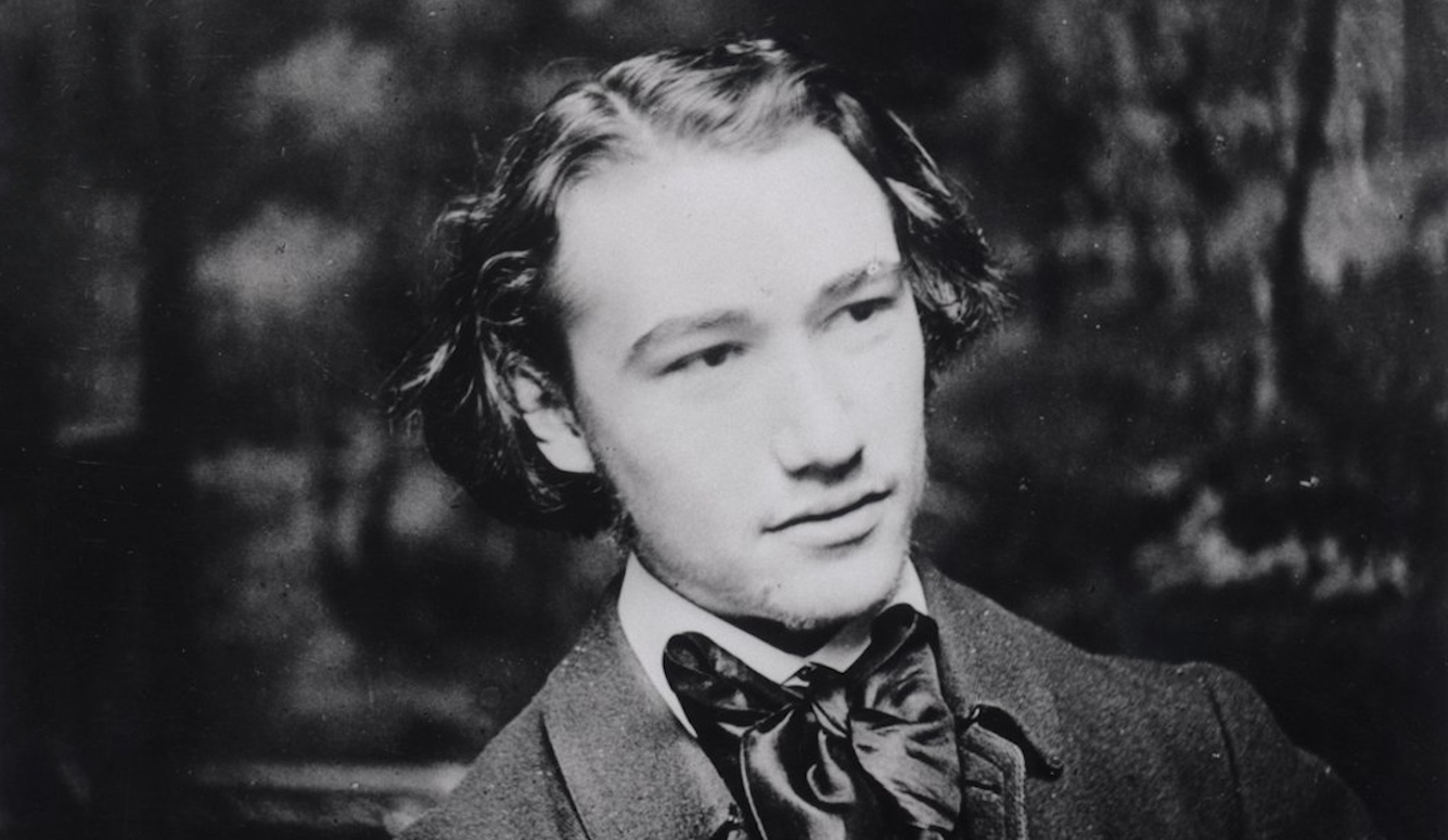 A black-and-white image of Gide as a young man, wearing a jacket and cravat.