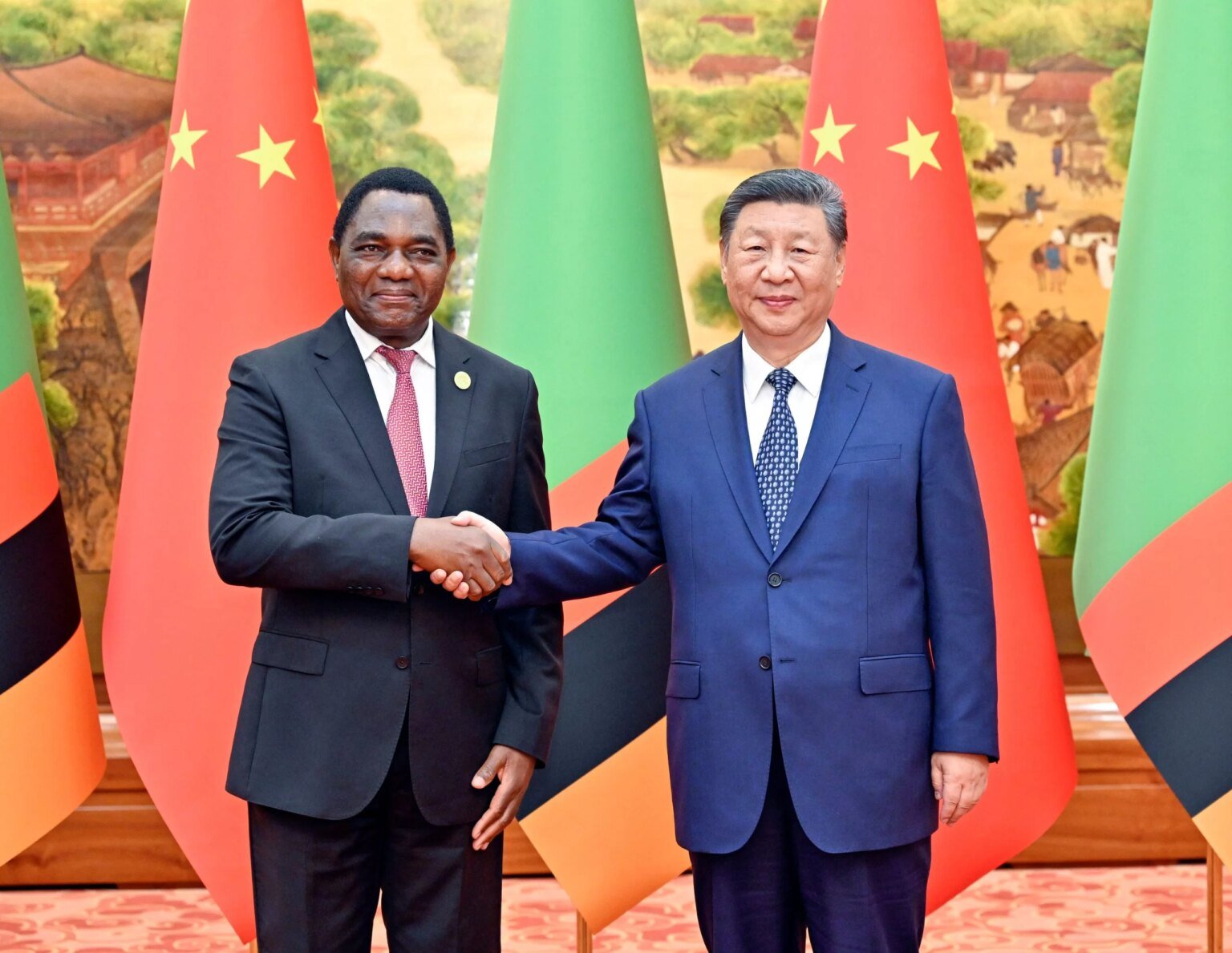 Zambian President Hakainde Hichilemamet  Chinese President Xi Jinping in Beijing in 2024. Photo: Yin Bogu/Xinhua/Alamy Live News

				
				
				
				
				Also read our CEO Jemimah Steinfeld’s view on the reasons for RightsCon’s cancellation
The cancellation of RightsCon, due to be held this weekend in Lusaka, Zambia has come as a shock. The global conference would have brought together thousands of advocates, technologists, academics, policymakers and others concerned with issues at the intersection of human rights and technology. However, for those Zambians who are abreast of the political direction their country is taking, it is not very surprising. Daniel Sikazwe, the secretary general of Zambian PEN, had feared that it could happen given the fact that the conference was to happen just three months before the general elections on 13 August 2026.
“The conference was going to show the world the state of human rights violations in Zambia at a time when the regime in power does not want this information known by the electorate,” he said, adding that since President Hakainde Hichilema assumed office in 2021, the human rights situation in the country has deteriorated. Hichilema’s government has enacted laws like the Cyber Security Act (2025) and the Cyber Crimes Act (2025) which human rights experts consider hostile to perceived dissent, criticism and political opposition. In fact, the Law Association of Zambia has petitioned the high court to declare provisions of the Cyber Crimes Act unconstitutional since it infringes on freedom of expression, speech, conscience, and association.
The Ministry of Information’s press release stating that the conference’s postponement was “necessitated by the need for a comprehensive disclosure of the critical information relating to key thematic issues proposed for discussion” suggests that the government was apprehensive about the direction that some of the conference sessions would take.
Charles Mafa, managing partner and editor at the Center of Investigative Journalism in Lusaka, Zambia attributed the postponement to China’s influence in the mining sector in Zambia. “On 18 February 2025, there was a major environmental disaster in Zambia: a tailings dam owned by a Chinese state-owned enterprise collapsed, releasing close to 50 million litres of highly toxic waste into the Kafue River ecosystem. This disaster and how investigations into it have been frustrated by the government was bound to be one of the big talking points at the conference to the discomfort of the ruling party,” he said.
David Ngwenyama, a well-known Zambian ecologist, reiterates Mafa’s point. “This is the same government that has done public relations work for the Chinese mining company, claiming that pollution has been neutralised and the conditions are back to normal,” he said, adding, “I would not be surprised if the postponement of the conference is yet another performance of Chinese power in Zambia.”
The fact that the venue where the conference was to be held – the Mulungushi International Conference Center – was partly built with Chinese funds has also made people wonder if China could have had a hand in the postponement of the event. There were also representatives from Taiwan due to speak at the conference. If all this is true, it raises serious questions about Zambia’s sovereignty.
For an African journalist like me, having RightsCon in southern Africa would have been a megaphone for human rights defenders and journalists to showcase the deterioration of human rights observance on the African continent and to put this on record.
It was also an opportunity for human rights defenders and journalists to come together as a family that shares the same values and dilemmas. There is immense power in this kind of gathering because it sends the powerful message: you are not alone in this work you are doing – everywhere in the world, there are people who are fighting for human rights observance  as you are, and paying the price as you are, sometimes the ultimate price. 
Finally, in the past, before the world changed in the Donald Trump direction where business and financial deals matter more than human life and human rights, resolutions made at these conferences had serious consequences for the nations labelled human rights violators, particularly in terms of isolating them as pariah nations (think of Iran, North Korea, Russia, after the invasion of Ukraine and the killing of Alexei Navalny –  and the killing of more than 50,000 people in the Gaza war.
These days, unfortunately, none of this seems to matter: Mighty nations can attack weaker nations at will, assassinate the entire cabinet, and turn this into a joke on social media.
Bombing “for fun”. Sad.

			
			
					
				
				
				
				READ MORE