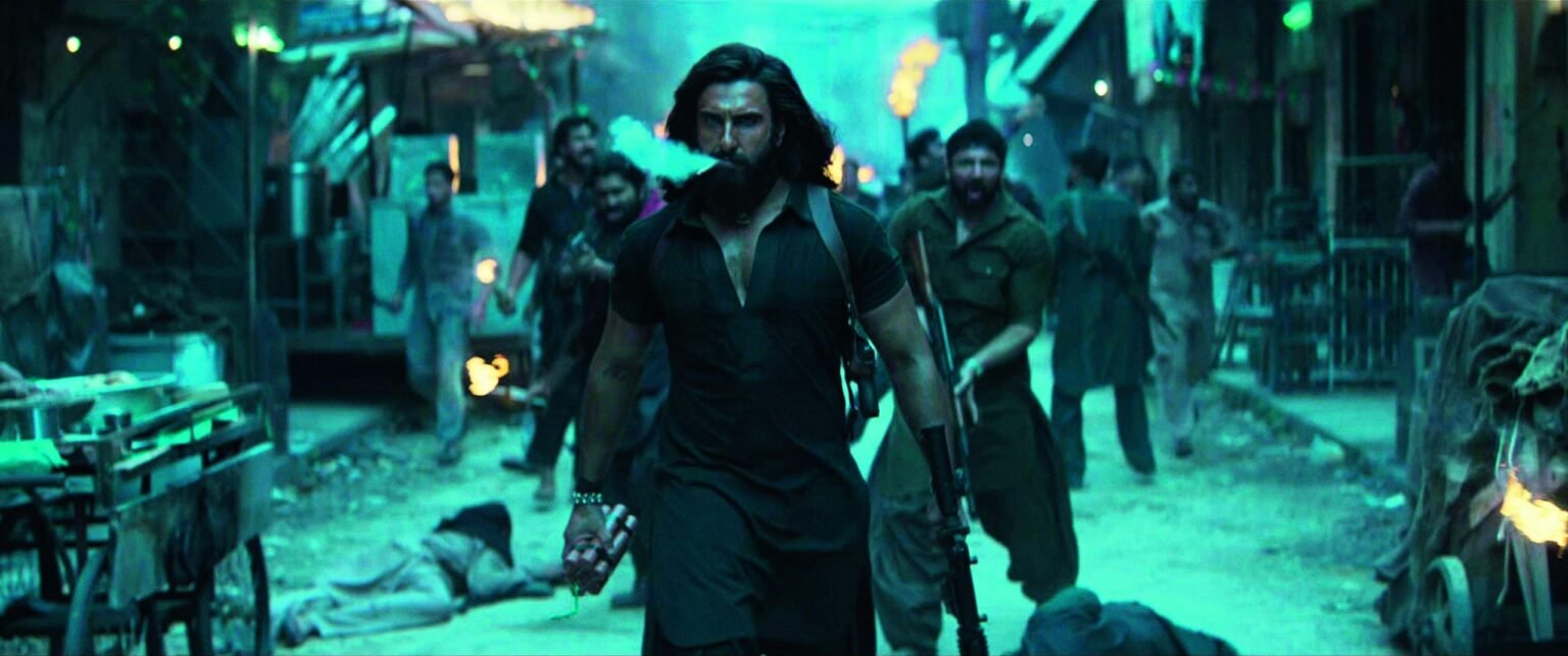 LEFT: Still from the film Dhurandhar which came out in India in 2025, directed by Aditya Dhar.
Photo: COLLECTION CHRISTOPHEL © B62 Studios – Benetone Films – Jio Studios/Alamy

				
				
				
				
				This article first appeared in the Spring 2026 issue of Index on Censorship, The monster unleashed: How Hungary’s illliberal vision is seducing the Western world published on 2 April 2026. 
Salim Mirza, played by one of India’s greatest actors, Balraj Sahni, stands on the wide platform of Agra railway station, as he waves goodbye to his sister and her children who are leaving for Karachi. India has been partitioned overnight but Mirza’s love for Agra, his home city, holds him back. He’s not like most of his fellow Muslims who are leaving en masse in search of a life they presume will be free from discrimination. As the story unfolds, Mirza’s small shoe manufacturing business endures spiralling losses, heightening his dilemma, but eventually Mirza decides to stay, braving the harsh realities of post-independence India.
Garm Hawa (Scorching Winds), made in 1974, is one of the greatest Hindi films on Partition and the geo-politics of India and Pakistan. It was made on a shoestring budget and the director Mysore Shrinivas Sathyu borrowed three quarters of the money from his friends.
In Garm Hawa, Karachi was positioned as a “land of hope” and Pakistan was not merely a land of barbaric violence. Though in reality Partition had caused enormous bloodshed on both sides of the border, resulting in the largest singular human displacement in the subcontinent’s history.
Even at the time, the film struggled to be released, held back by the Censor Board which cited communal sensitivity. But Garm Hawa finally saw the light of day at the Cannes Film Festival the following year and received international recognition.
The arguments for Garm Hawa’s subtle, heart-wrenching but humanist approach towards those troubled times after Partition are many. But what is most striking is the absence of hyper-nationalist discourse and “Islamophobia” from the public realm at the time. Interestingly, the term Islamophobia was only adopted later as sociological jargon.
The portrayal of Muslims
Hindi cinema has come a long way from the 1970s when a film could depict Muslims as real, honest people living ordinary lives and being forced to leave India for Pakistan. Now, cinema is showing Pakistan as a country of terrorists, crime, blood and gruesomeness with Karachi at the heart. The apogee of this trend is Dhurandhar which came out in 2025. The film is both a historic discourse and reflects the rise of hyper-nationalist cinema. It was a huge success at the box office, taking an extraordinary 0 million (13 billion rupees).
The cinematic change hasn’t happened overnight, it is intertwined with India’s social transformation and compounded by ideology.
A cursory search of films themed on India Pakistan relations throws up mostly espionage thrillers or military dramas. Some of the films were released as early as 1997, like Border set during the India-Pakistan war of 1971. In 2003, there was LOC: Kargil about the 1999 border war between India and Pakistan and the 2007 movie, 1971, was also about the Indo-Pak war. They are more nuanced in comparison with what is happening today and all came out a long time before the current batch of hyper-nationalistic cinema even got the wind in their sails; tellingly, a sequel to 1997’s Border was released on 23 January 2026. On the whole, the late 1990s films laid the groundwork for more definitive later works which showed Hindu heroism and Muslims as the enemy, like for instance The Kashmir Files, Uri The Surgical Strike, The Kerala Story, Raazi, Fighter or Gaddar 2. All are premised on the idea of “patriotism” and “bravery” as predominant emotions and they enjoy a Bollywood eco-system willing to back such projects.
Patriotism is box-office gold
In a typical chicken and egg scenario, a long list of producers are happy to fund money spinners. The latest “patriotic” films like Dhurandhar and Chhaava were among the highest-grossing films of the year. And as there is such massive demand for stories of Muslim “othering”, more films are getting made.
Interestingly, the universe of propaganda films made in 2025 is varied, a period film, Chhaava is focused on Mughals and Marathas. Films like Sky Force and Tanvi The Great are political thrillers. Diplomat, another release, concentrates on Islamic terrorism while Sarzameen is an army thriller based in Kashmir. Dhurandhar, the most successful one of all, is significant because it shifts the film-making grammar of its predecessors and emerges as a gripping entertainer with upscaled cinematic techniques. Wickedly crafted, it is primarily a spy thriller, but it is also a gangster movie and a story of regional political conflict reflecting Pakistan’s internal politics. The genres are mixed together to churn out a brutally violent film, hitherto unseen in Hindi cinema.
The screenplay deploys a smart structure with short segments leading from one to the other. This is mounted with a chartbusting techno Qawaali, (a form of Sufi devotional singing) originally used in the iconic 1960s superhit Barsaat. There are high velocity action shots either in extra close-up or from drone cameras. The film is set in the gory, trash-littered streets of a working-class neighbourhood of Karachi. And the characterisation is original. The lead character Hamza Ali Mazari (later unmasked as Indian army officer Jaskirat Singh Rangi), goes undercover as a member of Baloch mobster Rehman Dakait’s gang. Dakait is played by well-known and much-loved Bollywood actor Akshaye Khanna, Mazari by one of the highest paid younger generation actors Ranveer Singh. Dhurandhar appears to be a slick, edgy, hard-hitting movie not your typical hyper-nationalist puff. It speaks its language of bigotry differently, laced with codes of love-hate for the Muslim aesthetic, like its use of popular qawwali and ghazals (forms of music mostly associated with Islamic cultures), spliced with the portrayal of sado-masochistic Muslim men – and women – trying to break free from their “prison”.
Younger audiences have lapped up Dhurandhar because they have already been weaned on the unsettling universe of Hollywood’s Kill Bill and Sin City. And the massive distribution network behind the film with 3,000 screenings worldwide, 390 in North America alone, has created a juggernaut guaranteeing the movie’s success.
Such intertwinings are intricate and clever, a stark contrast to a handful of cinemas with small budgets but powered by a gritty resolve to tell a story rising from the very same geo-politics but which still manage to remain humane.
Ikkis (meaning 21) was released in 2025 without much fanfare, while Dhurandhar was a crushing box office hit. Ikkis is a tenderly told true story of a young army man who died in the Indo-Pak war in 1971 and the events that follow next, when his octogenarian father travels to Lahore for a college reunion thirty years after his son’s death. No jingoism, no slogan-mongering, it casts a newcomer Agastya Nanda, together with the legendary actor Dharmendra who died a few days before the film’s release to pose some vital humanitarian questions connected to war.
Ikkis was reportedly made with a budget of between .7 million and .1 million and was released on 1 January. The film was distributed by powerhouse brands – quite startling as one of them is also the distributor for Dhurandhar – yet it hasn’t been able to catch a break so far and has been a box office flop. The film got some love from a handful of audiences willing to argue for peace.
So, it is much more conducive for propaganda films like Dhurandhar to be made (its sequel Dhurandhar 2 is ready for a March release). A polarised view of the world, where Pakistan and Muslims are baddies and Hindus and Indians are goodies, is driving enormous profits for Bollywood, so no wonder the movie moguls are not stopping.

			
			
					
				
				
				
				READ MORE