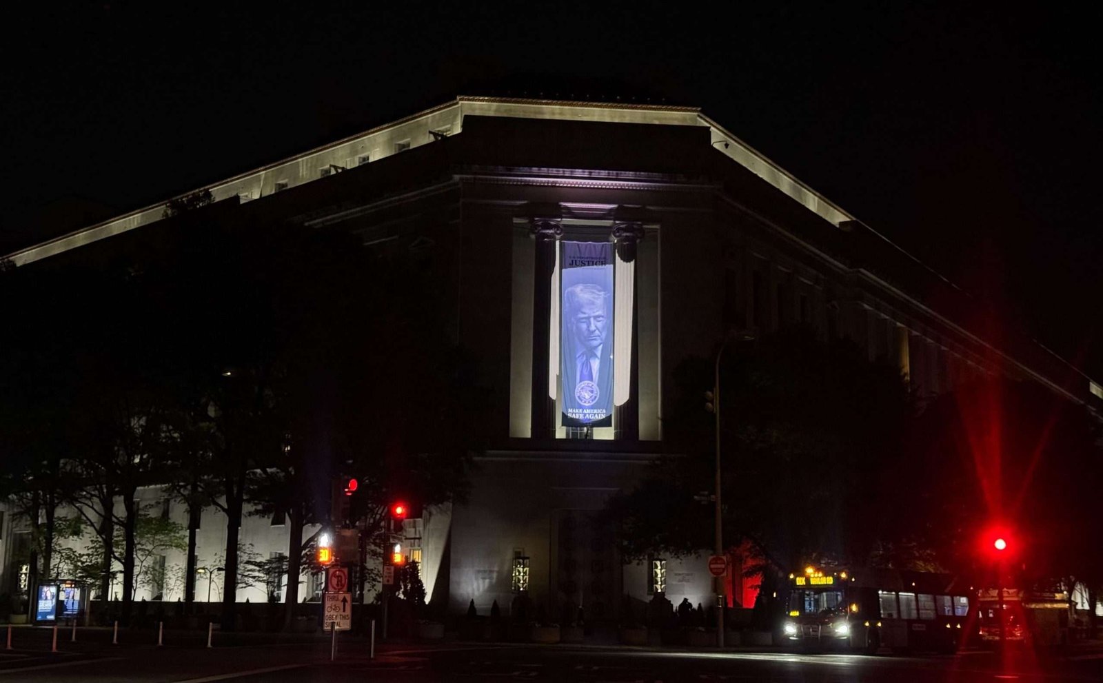 A banner featuring Donald Trump is seen hanging on the Justice Department