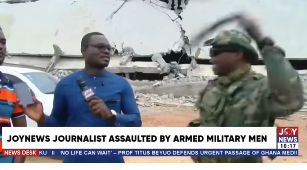 A soldier beats a man being interviewed by Joy News anchor Carlos Lorlornyo Atsu Calony
